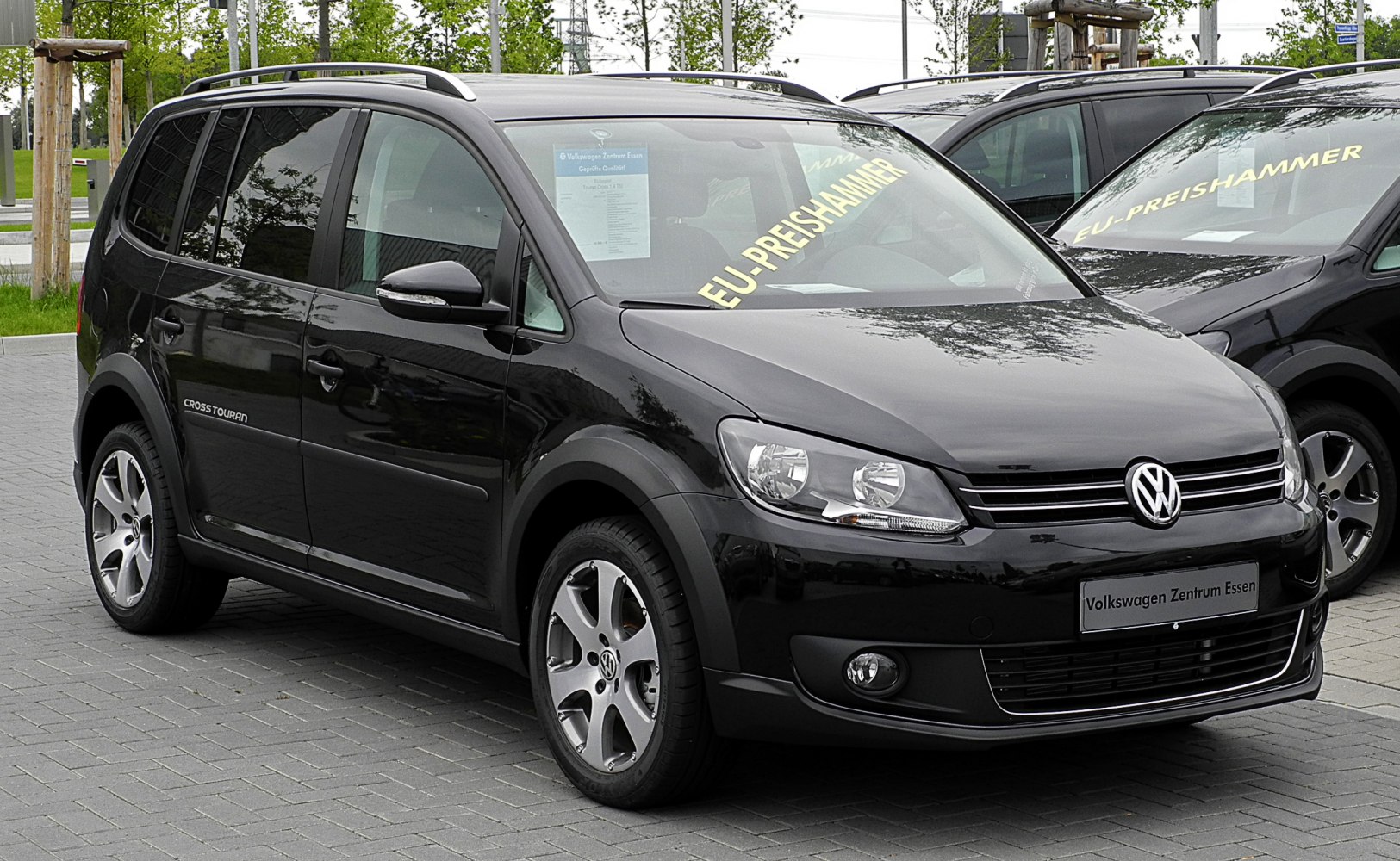 Black compact MPV front side with alloy wheels and roof rails