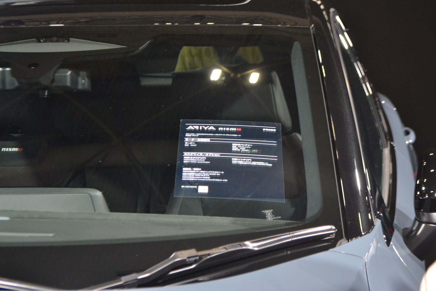 Windshield with an interior info sheet and visible windshield wiper