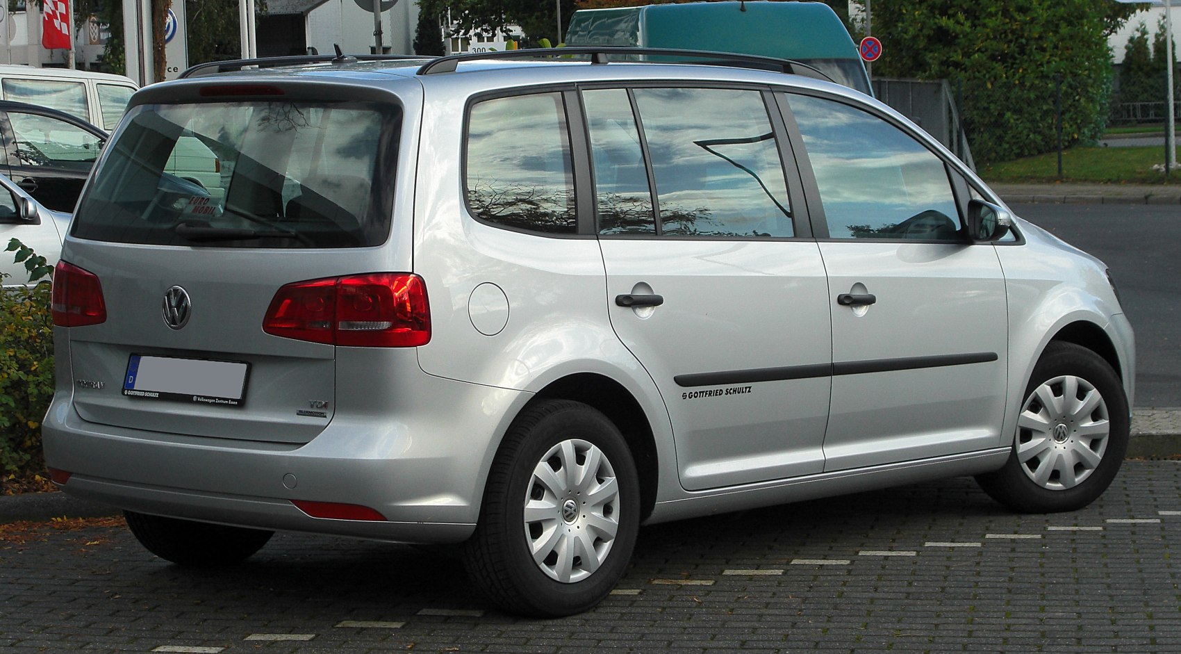 Rear side view of a silver multi-purpose vehicle with distinctive rear lights.