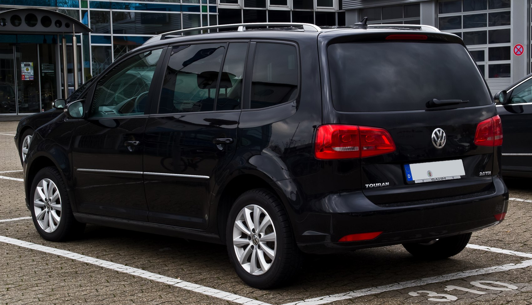 Rear and side view of black MPV with alloy wheels and tinted windows