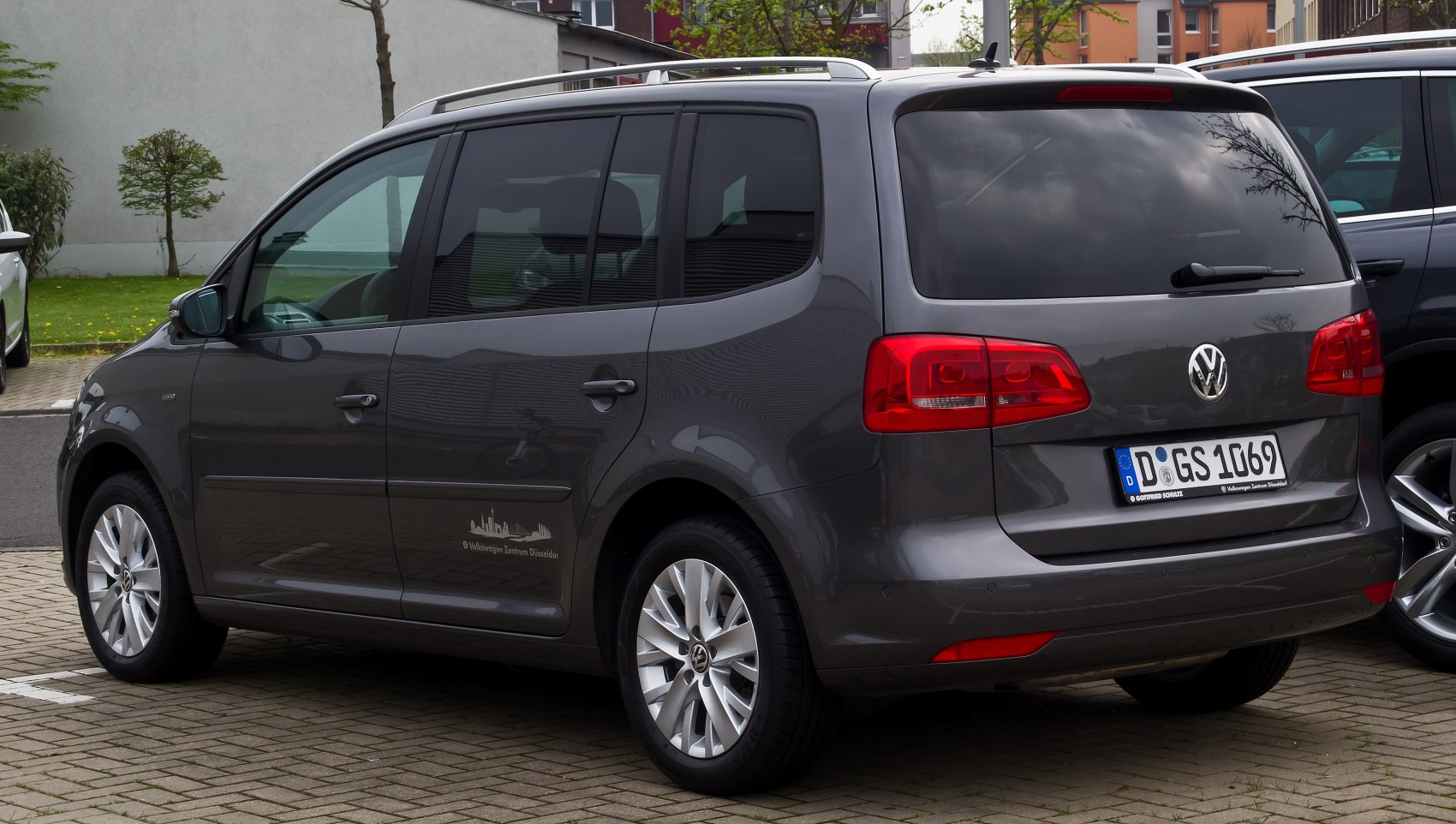 Rear side view with tail lights and alloy wheels