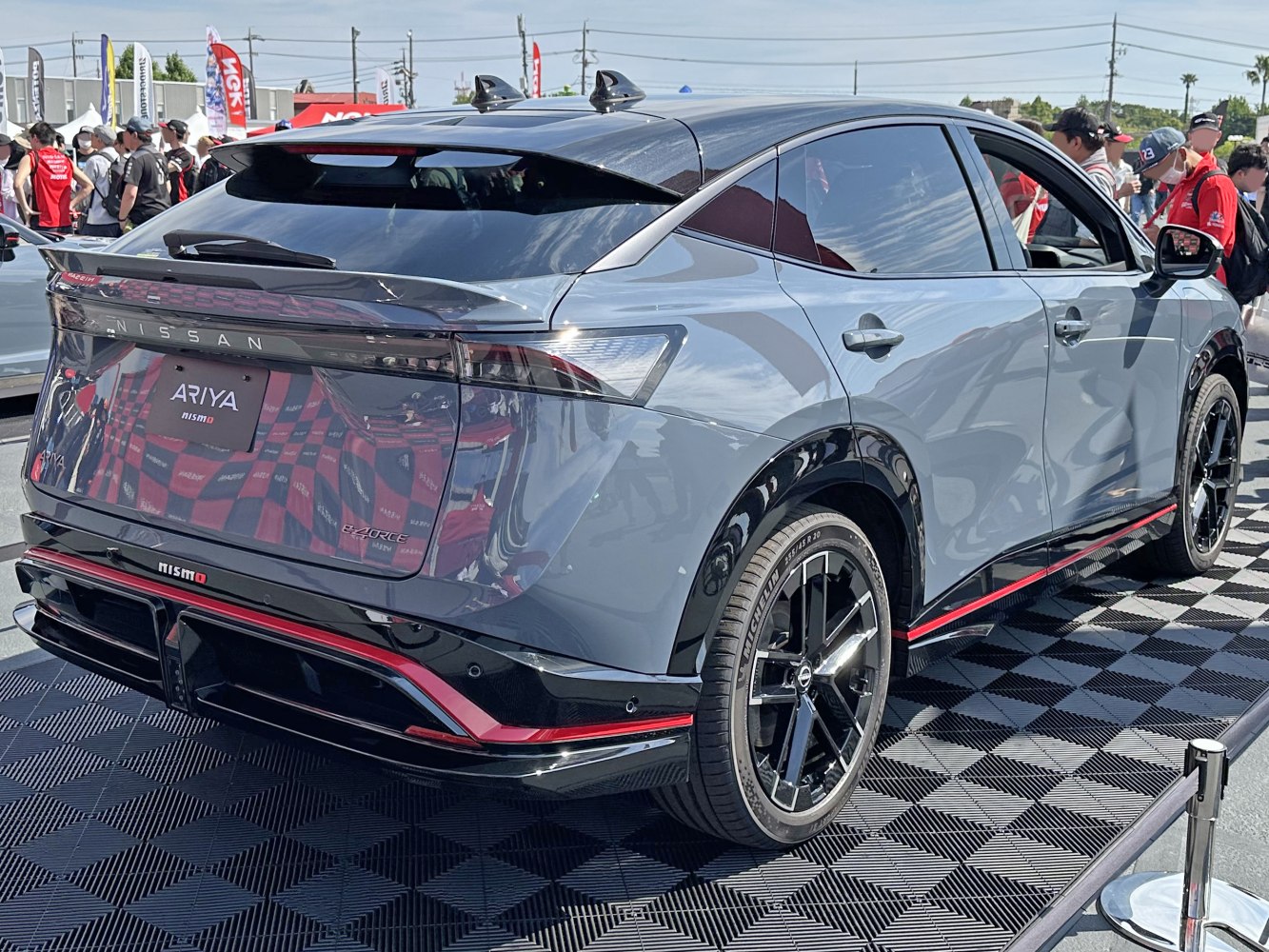 Rear view with aerodynamic taillights and sporty black alloy wheels.