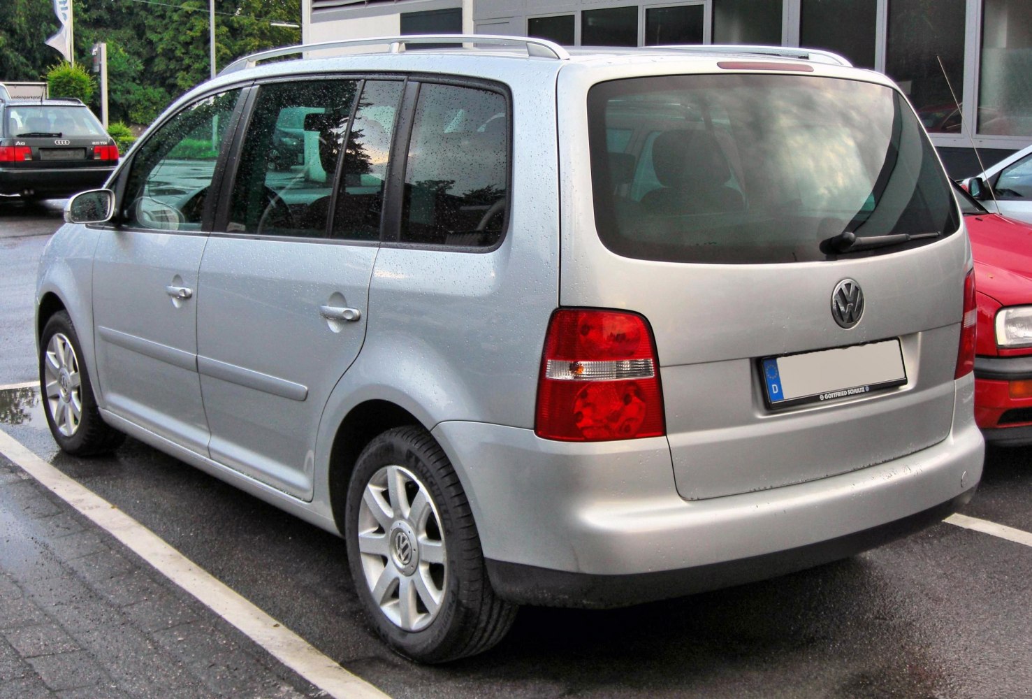 Silver MPV rear side profile with distinctive rear lights
