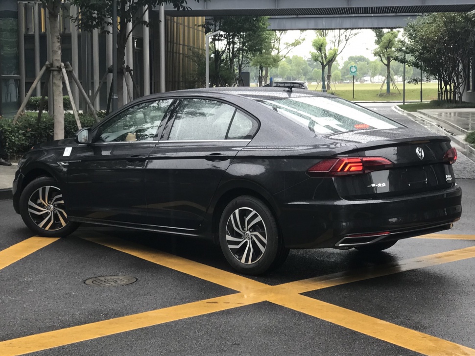 Rear and side profile of black sedan with LED taillights and alloy wheels