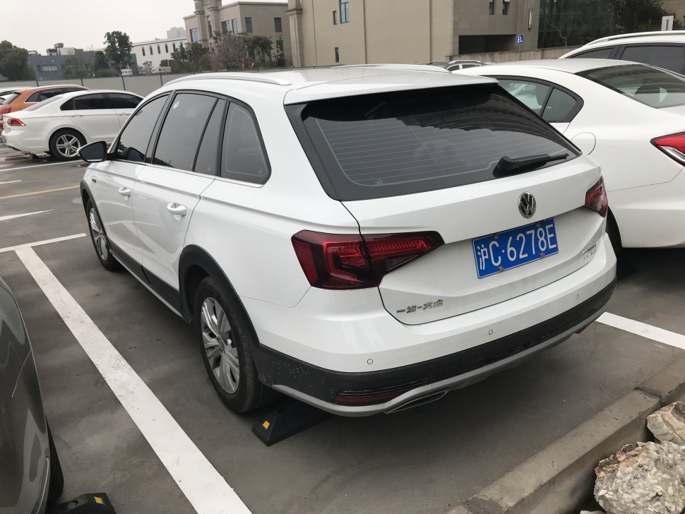 Rear and side view of a white wagon with modern taillights and rugged trim