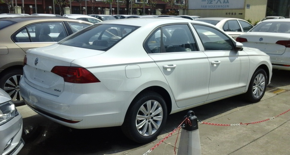 Rear side profile of a sedan with alloy wheels and distinct tail lights