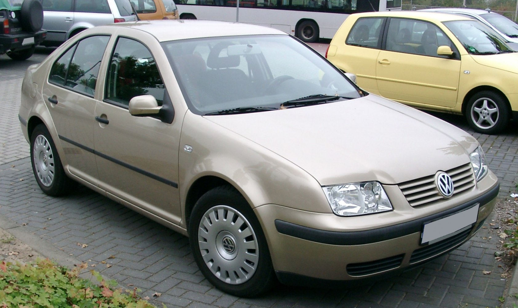 Front and side view of a sedan with distinctive headlight and body shape