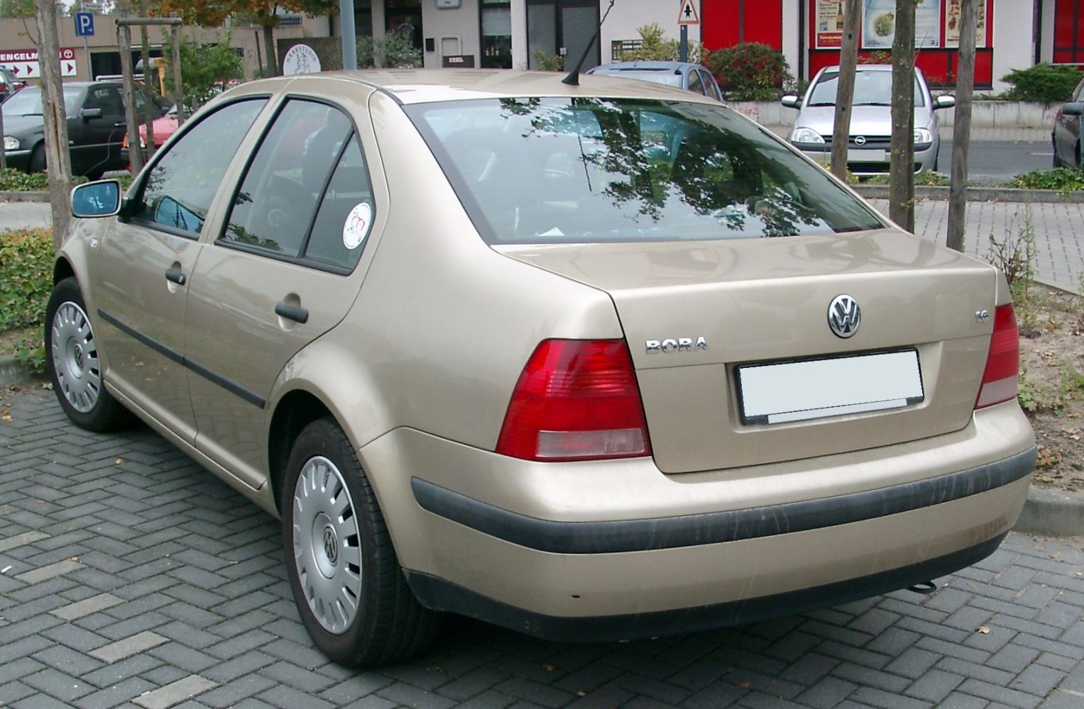 Rear sedan with red tail lights and silver alloy wheels