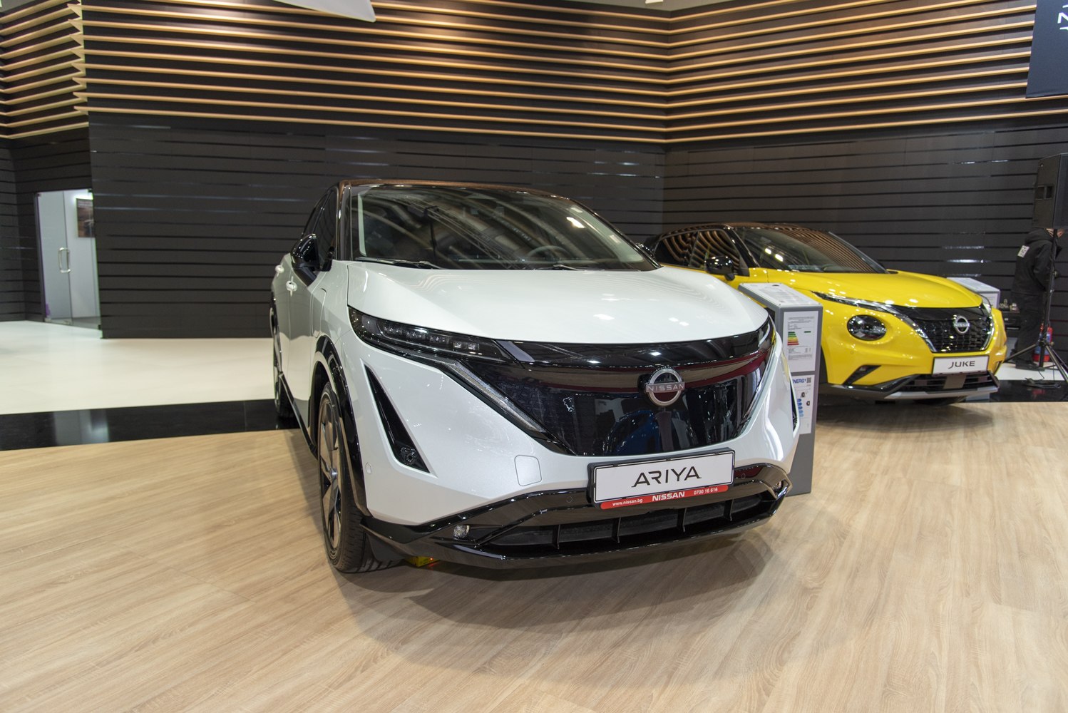 Front view of sleek electric SUV with modern headlights and prominent grille.