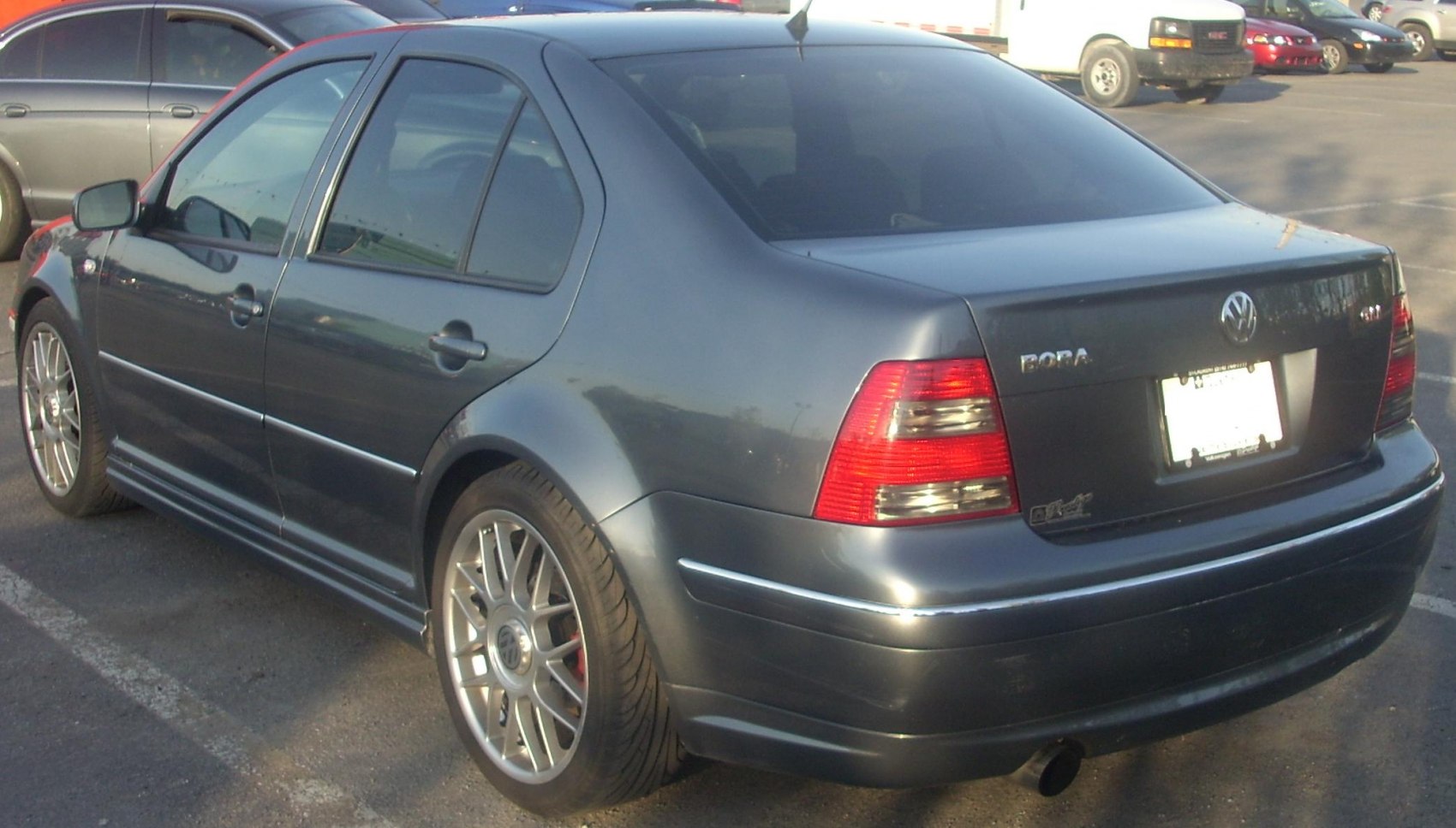 Rear three-quarter view of a sedan with alloy wheels and taillights
