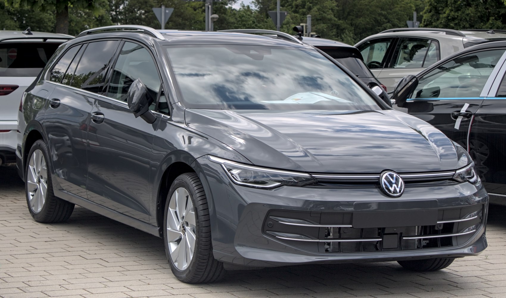 Front and side profile of sleek estate with modern headlights and alloy wheels