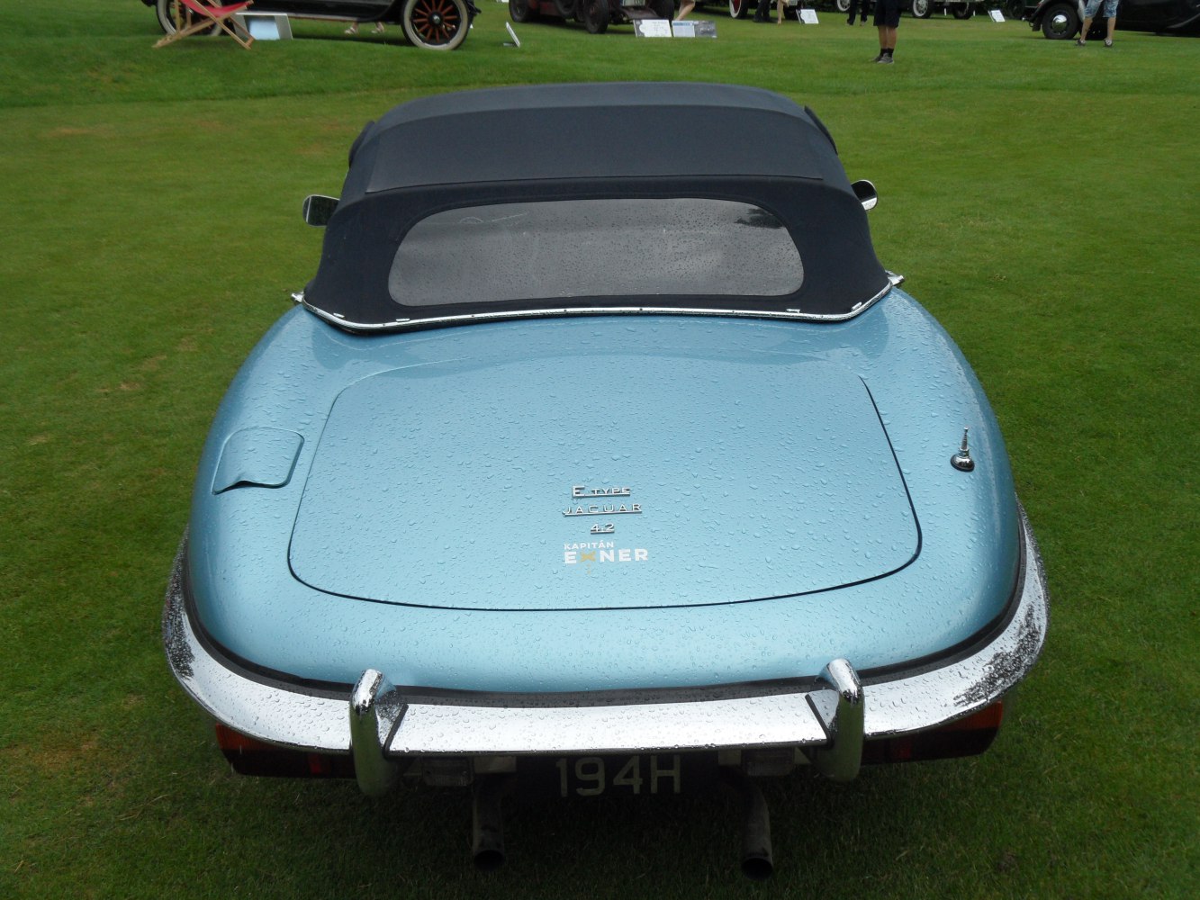 Rounded rear trunk and black soft top roof of a convertible