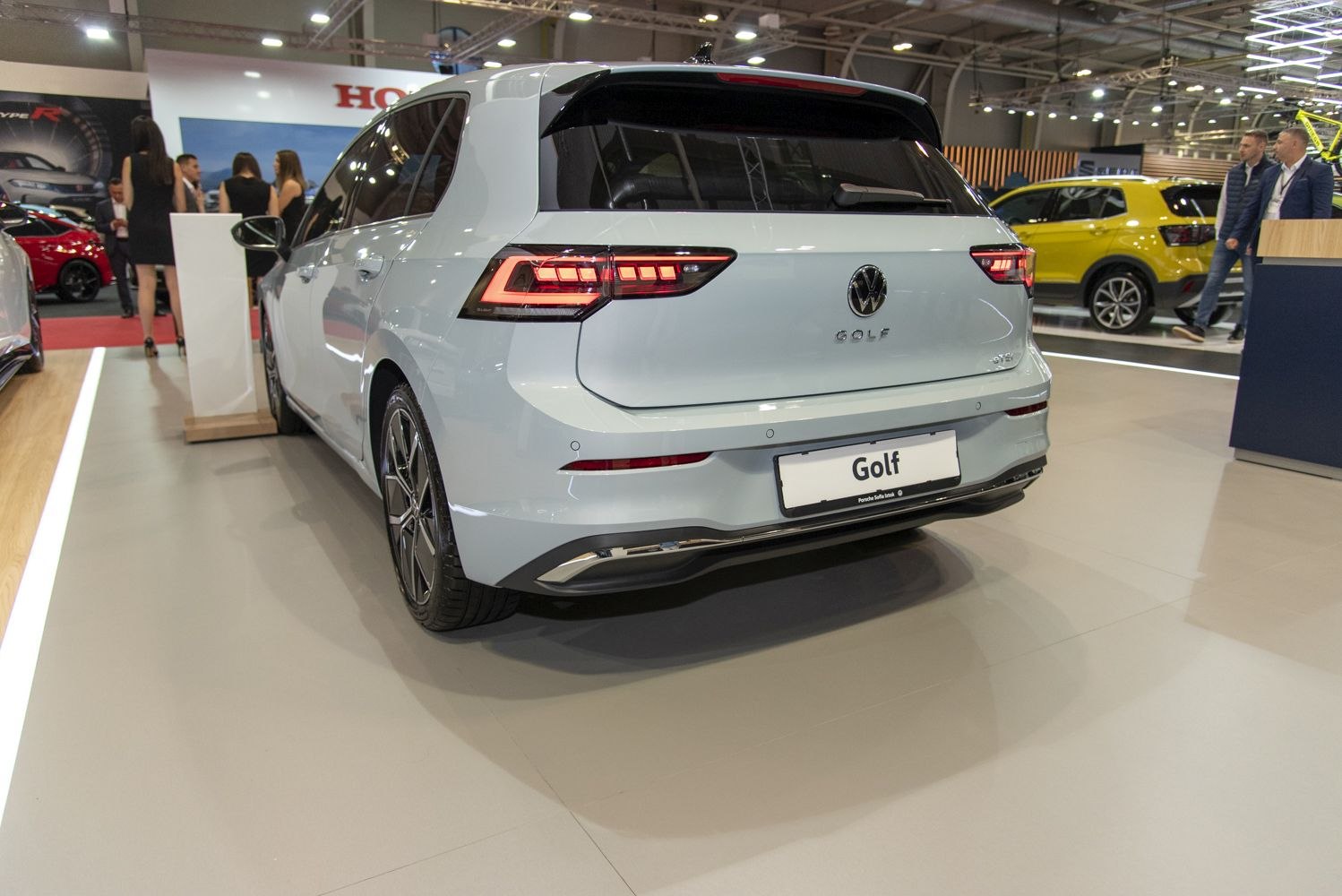 Rear view of a hatchback with modern LED tail lights at an auto show