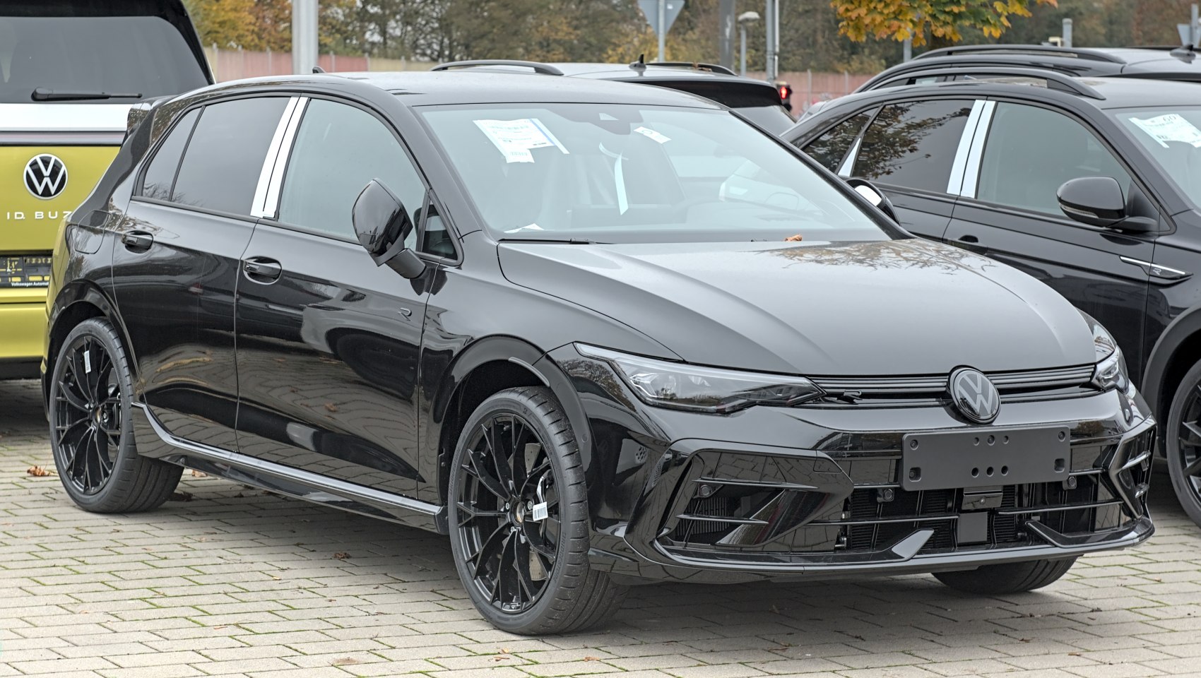 Black hatchback with sleek headlights and sporty alloy wheels
