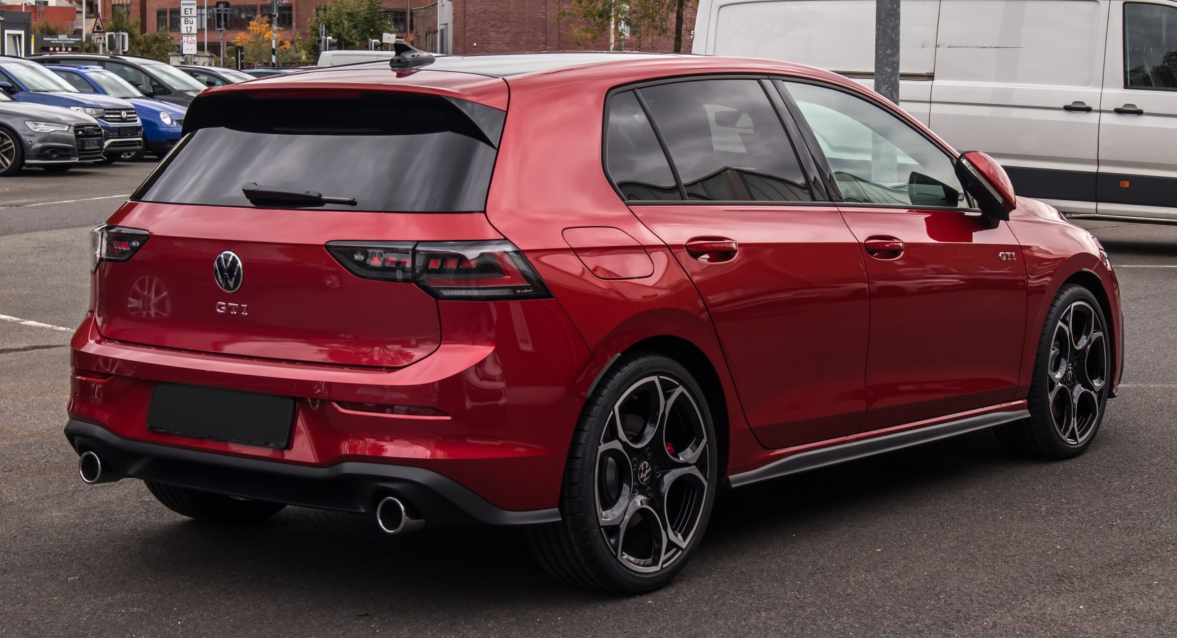 Red hatchback rear and side with dual exhausts and distinctive tail lights