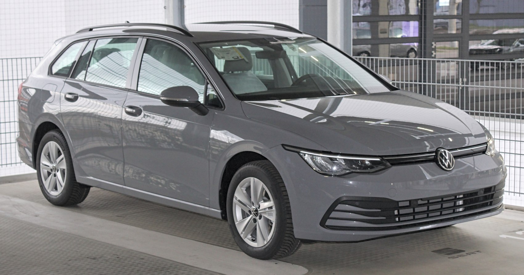 Gray modern compact wagon with sleek front and alloy wheels