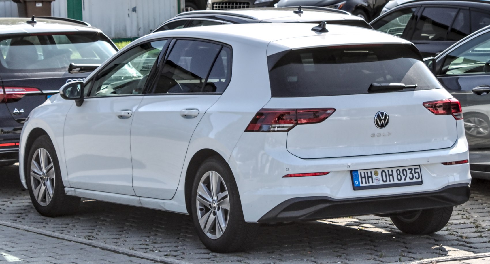 Rear view of a white hatchback with modern taillights and five doors.