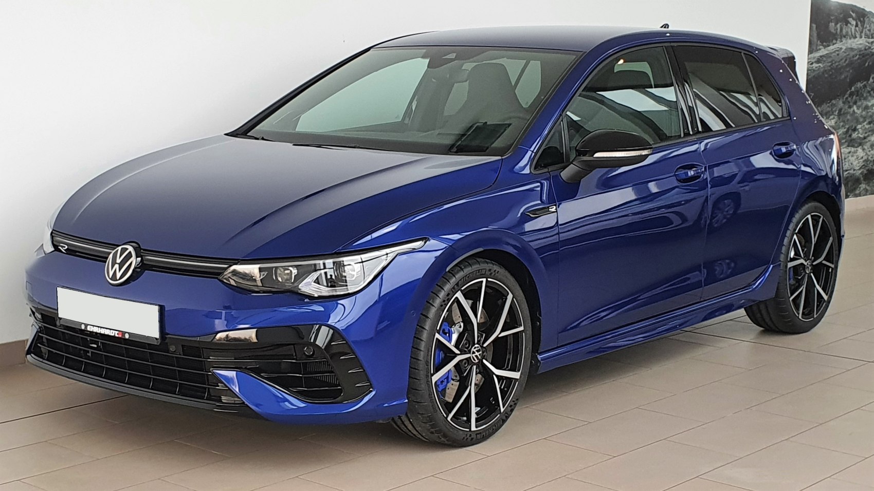Sporty blue hatchback front, detailed headlights, alloy wheels