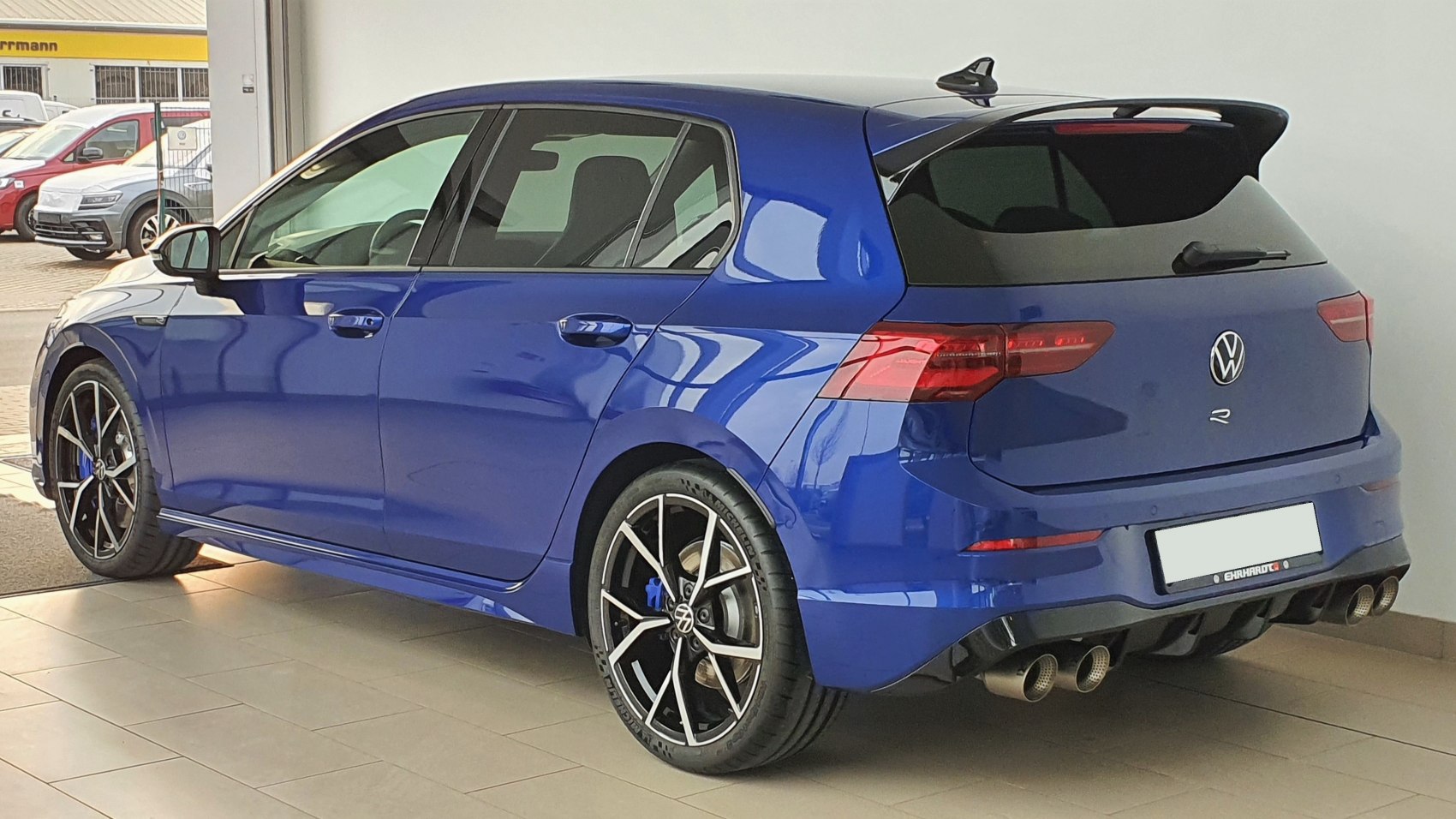 Blue hatchback rear-side with alloy wheels and quad exhausts
