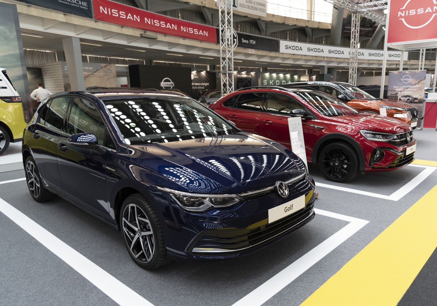 Front and side view with sharp headlights, alloy wheels, and sleek grille