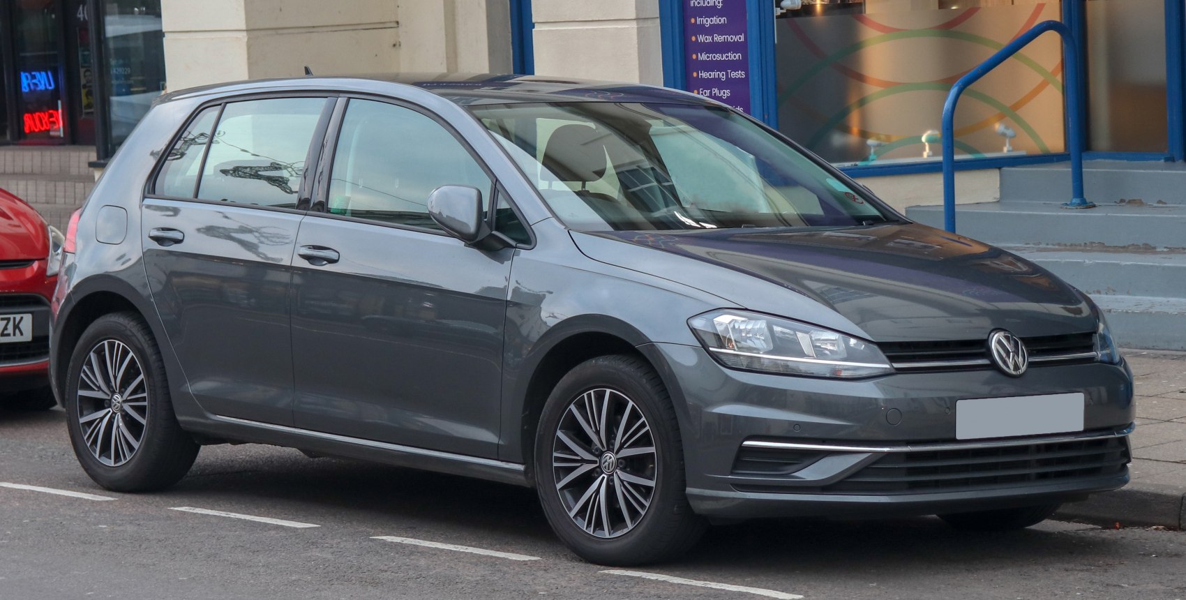 Compact 5-door hatchback with alloy wheels and modern headlights in urban setting