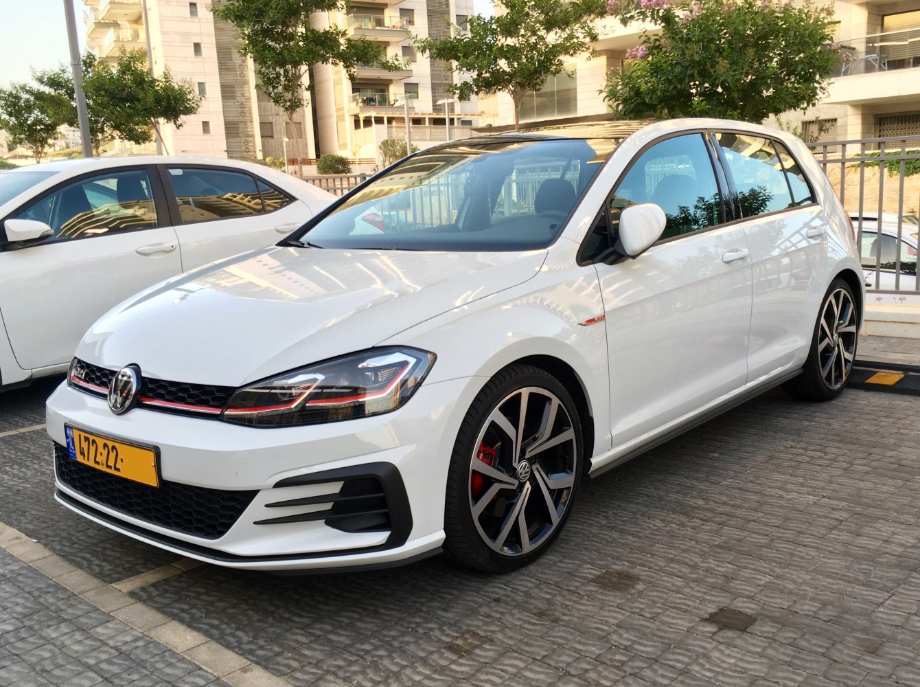 White 5-door hatchback with LED headlights and sporty alloy wheels