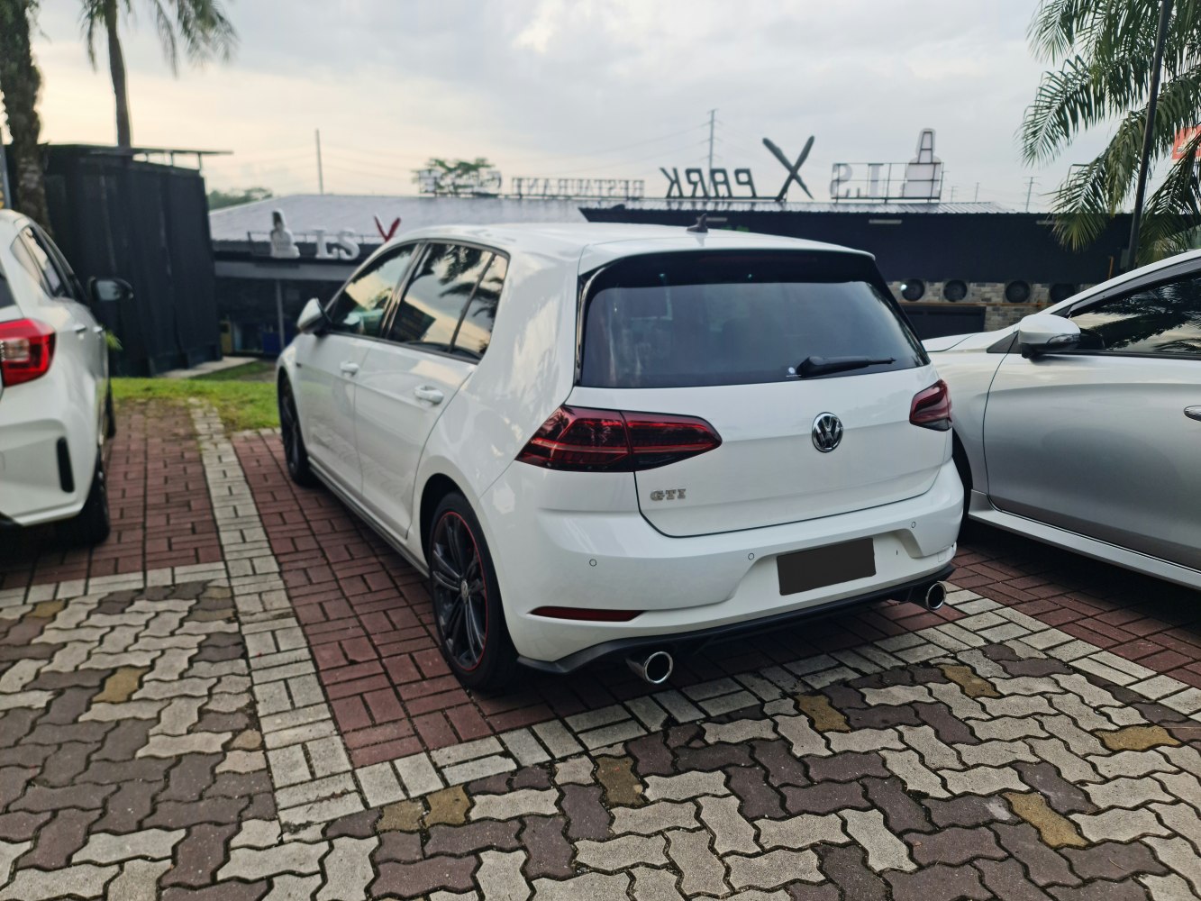 Rear view of a 5-door hatchback with distinctive sporty taillights and dual exhausts.