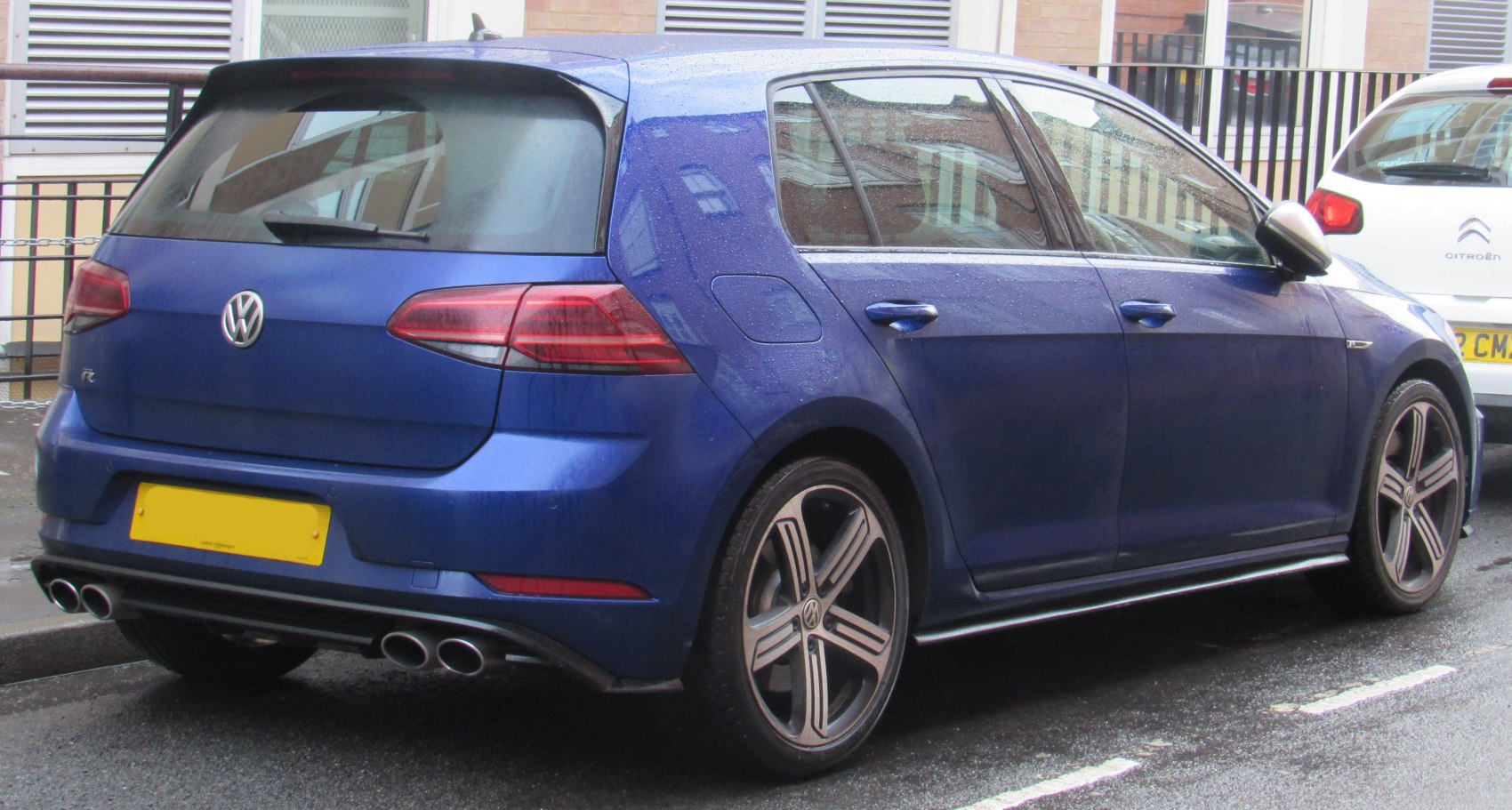 Rear view of sporty hatchback with quad exhaust and alloy wheels