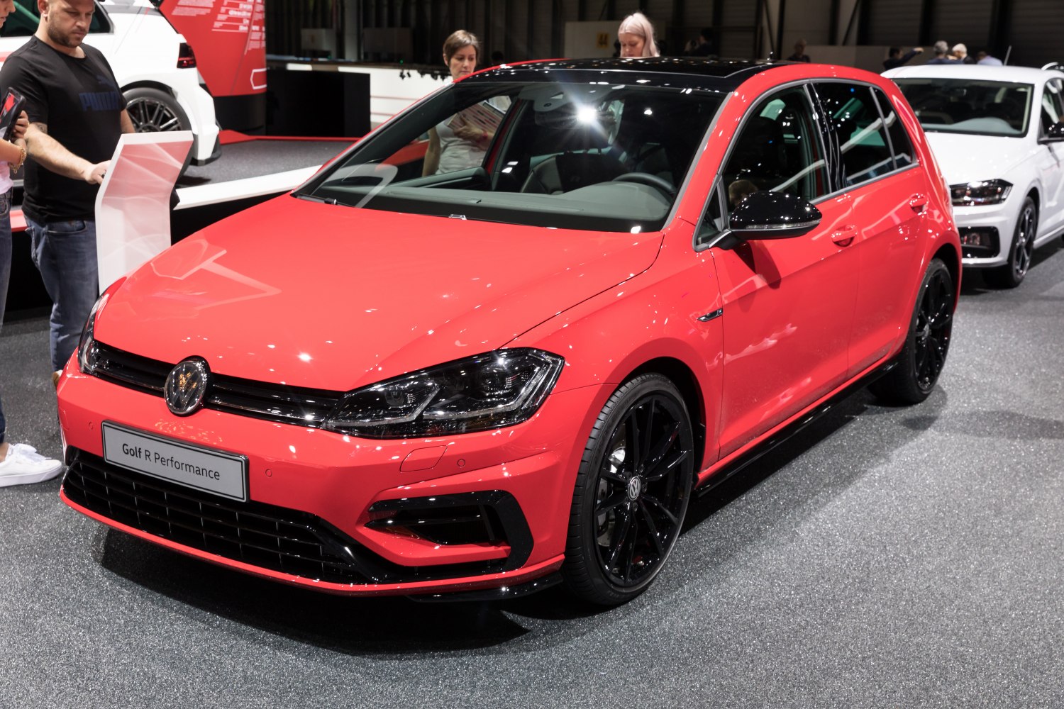 Red 5-door hatchback with black rims and sporty front design