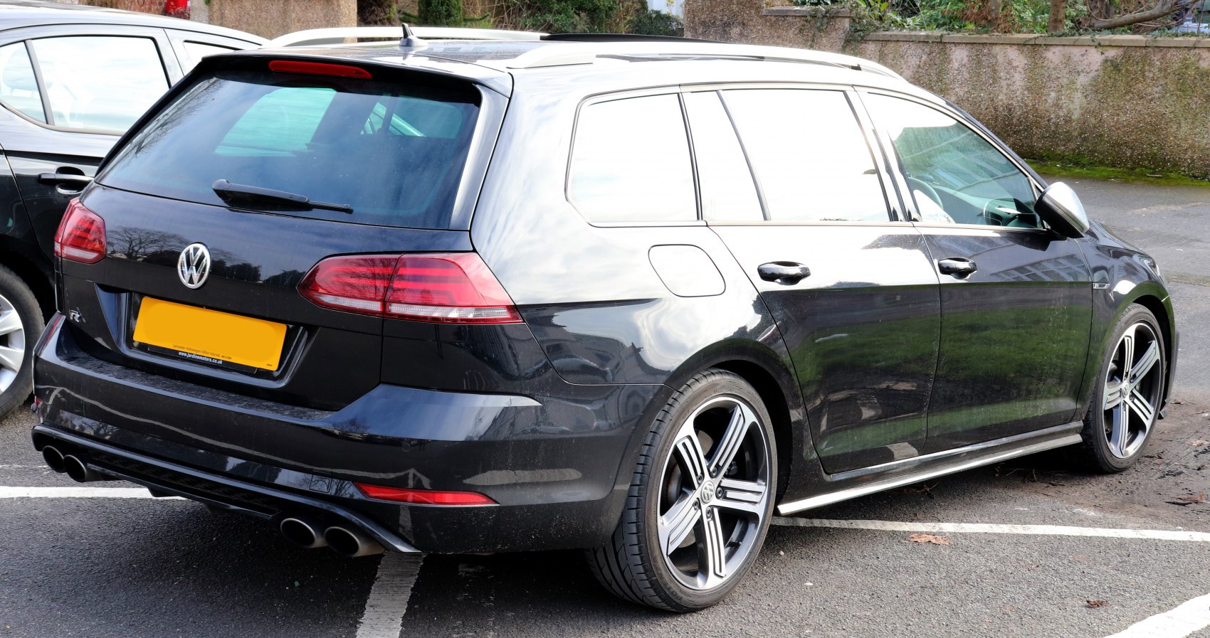 Rear and side view with distinctive taillights and alloy wheels