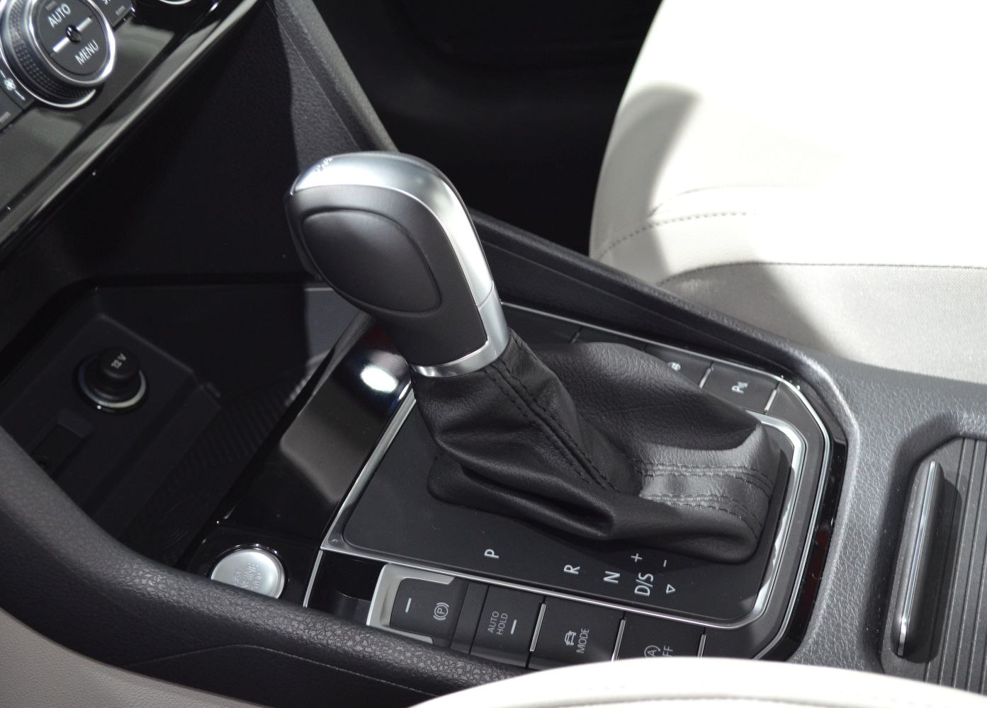 Gear shift lever and nearby control buttons in car interior