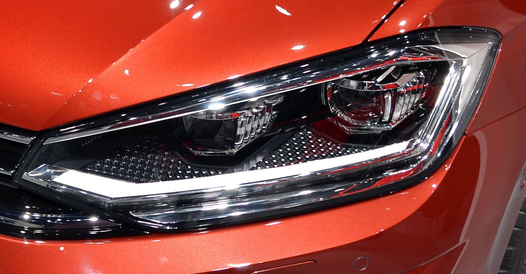 Close-up of a modern car headlight with LED elements and chrome details