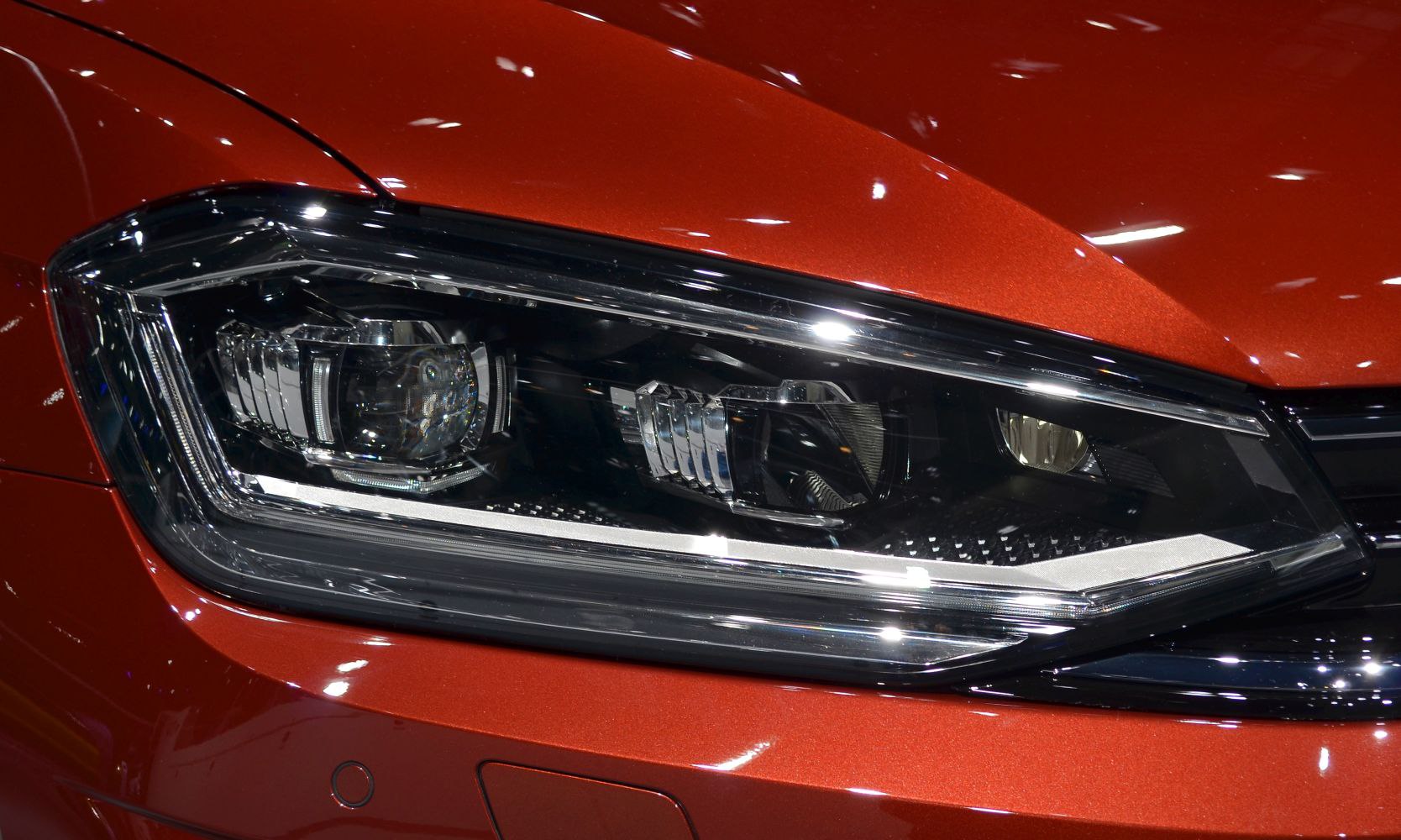 Close-up of modern LED and reflector car headlight