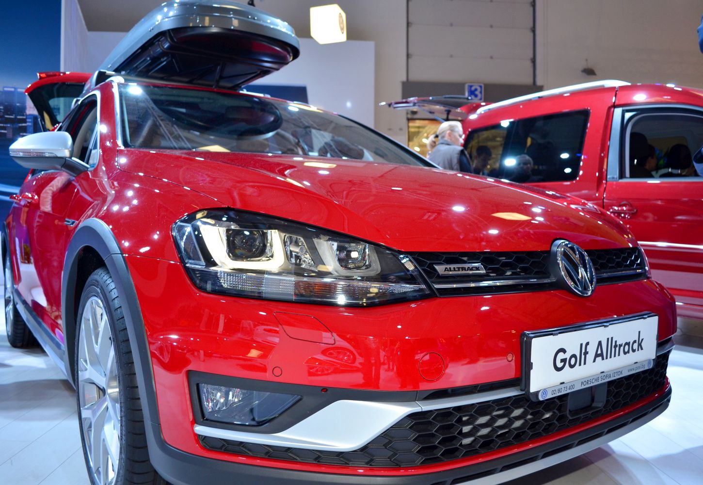 Close-up of front LED headlights and honeycomb grille on red vehicle