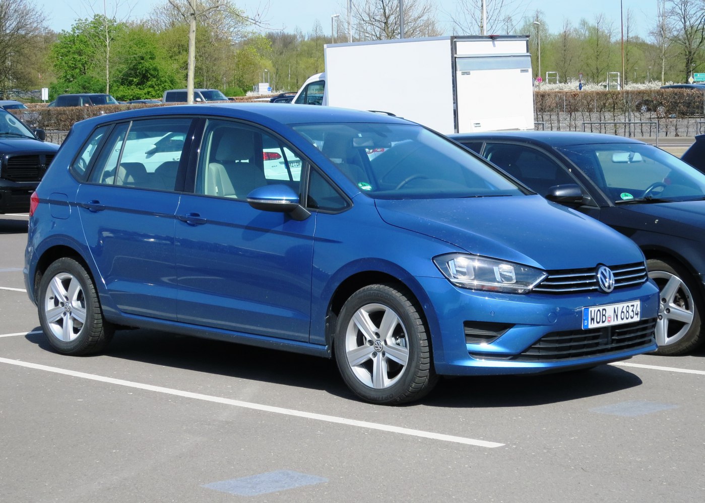 Blue 5-door compact MPV with alloy wheels and modern headlights