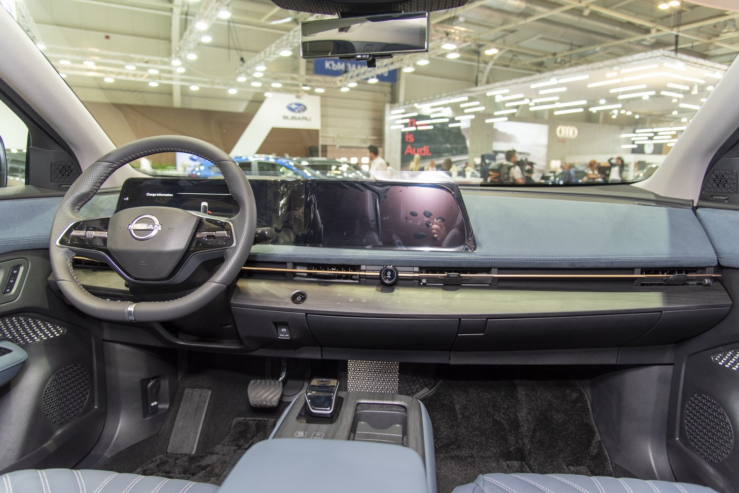 Digital dashboard display and modern steering wheel in car interior