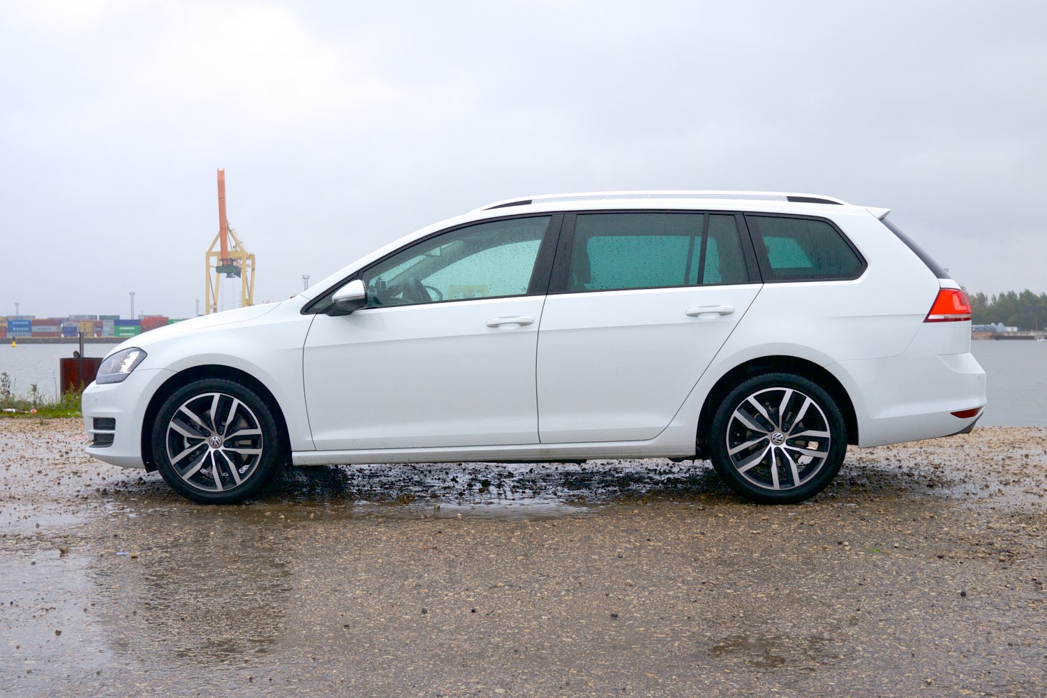 White mid-size station wagon with alloy wheels, side profile