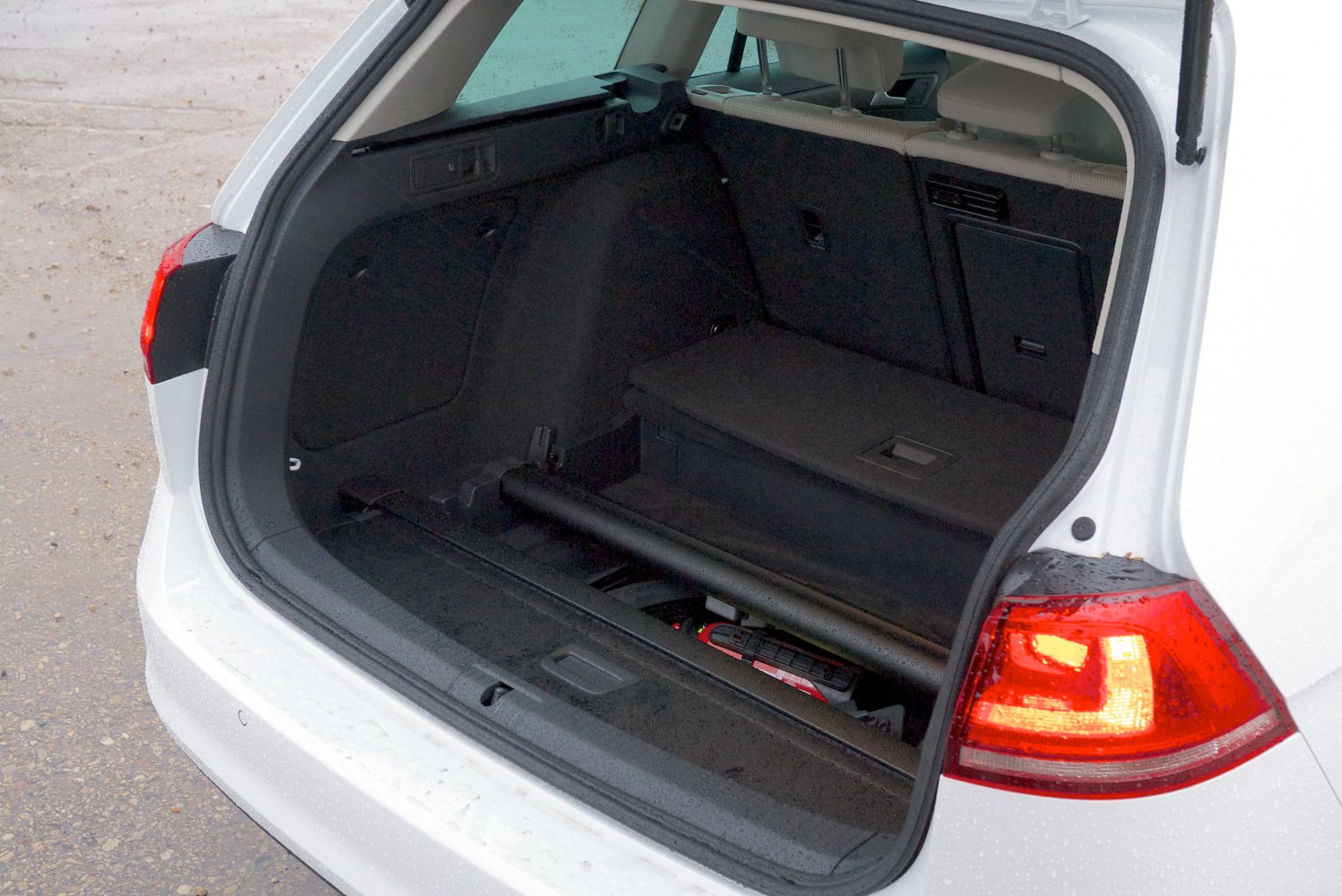 Open trunk space with storage compartments and rear light detail