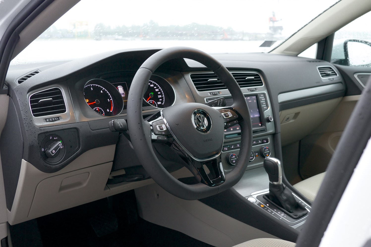 Modern car interior with multifunction steering wheel and automatic gear shifter