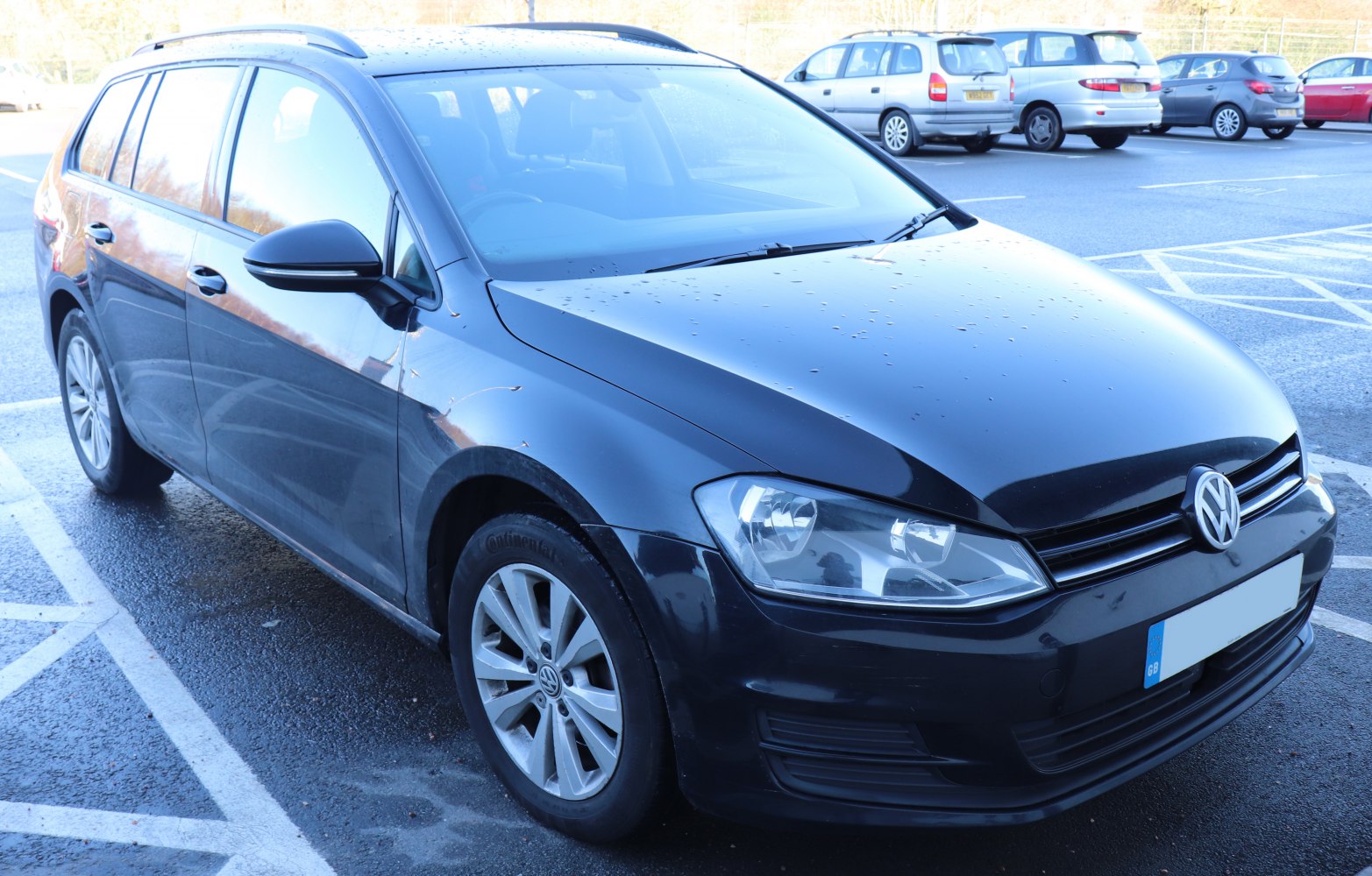 Front three-quarter view of a black Volkswagen hatchback wagon