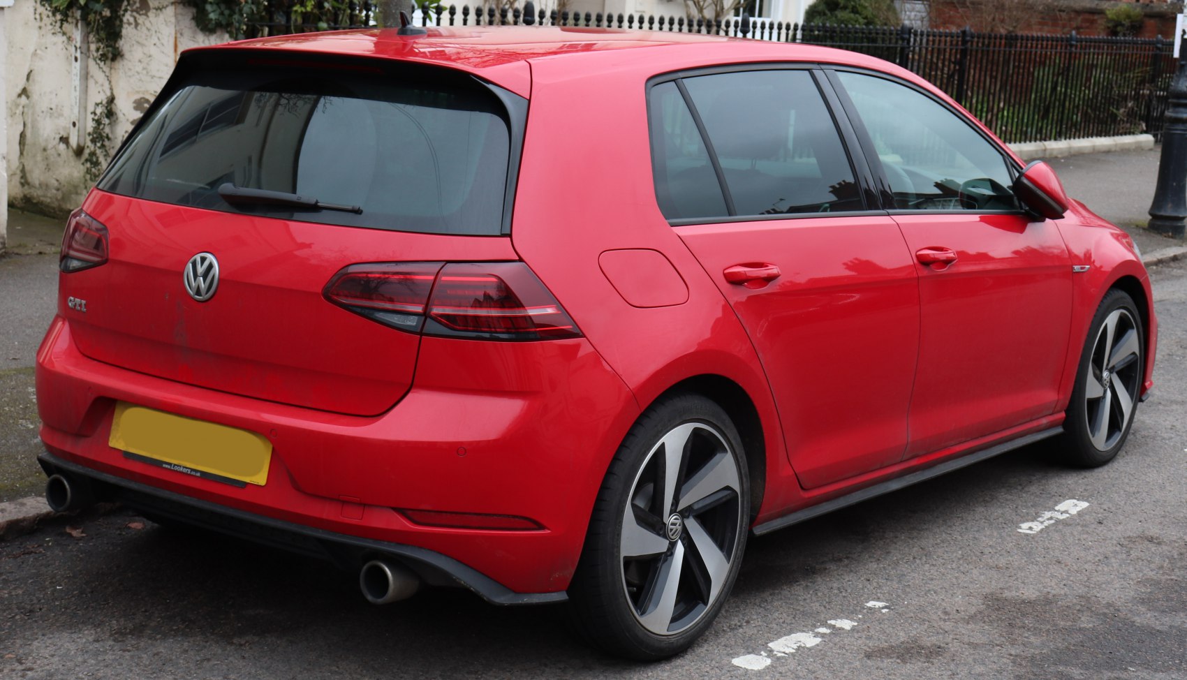 Red hatchback with dual exhaust and alloy wheels