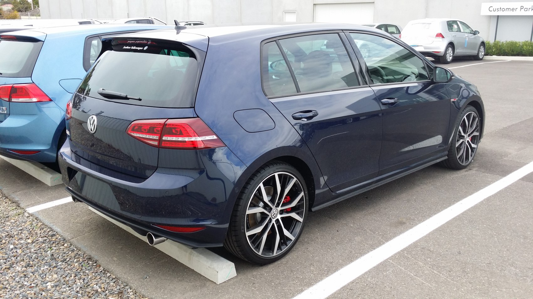 Rear side view of 5-door hatchback with sporty alloy wheels