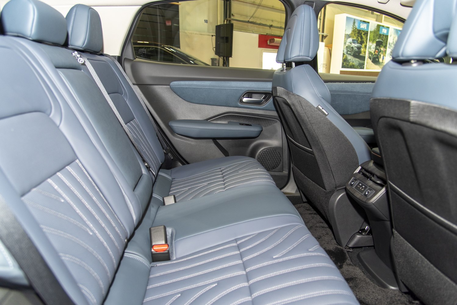 Spacious rear seating with premium stitched upholstery and detailed door panel.