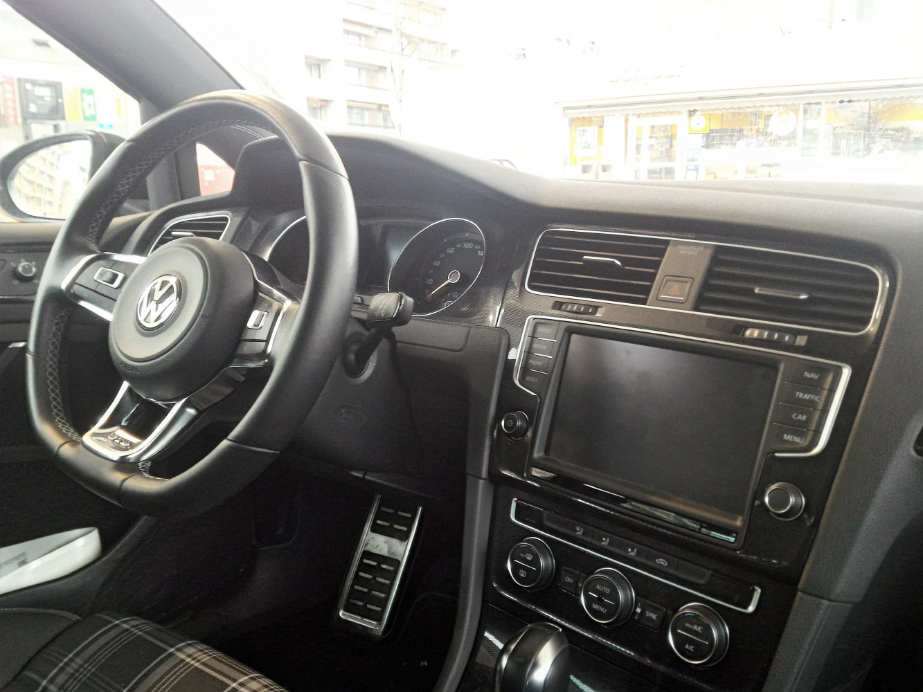 Steering wheel and dashboard with infotainment system and climate controls
