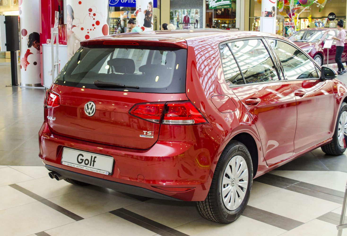 Red 5-door hatchback rear with TSI BlueMotion badge and dual exhaust pipes