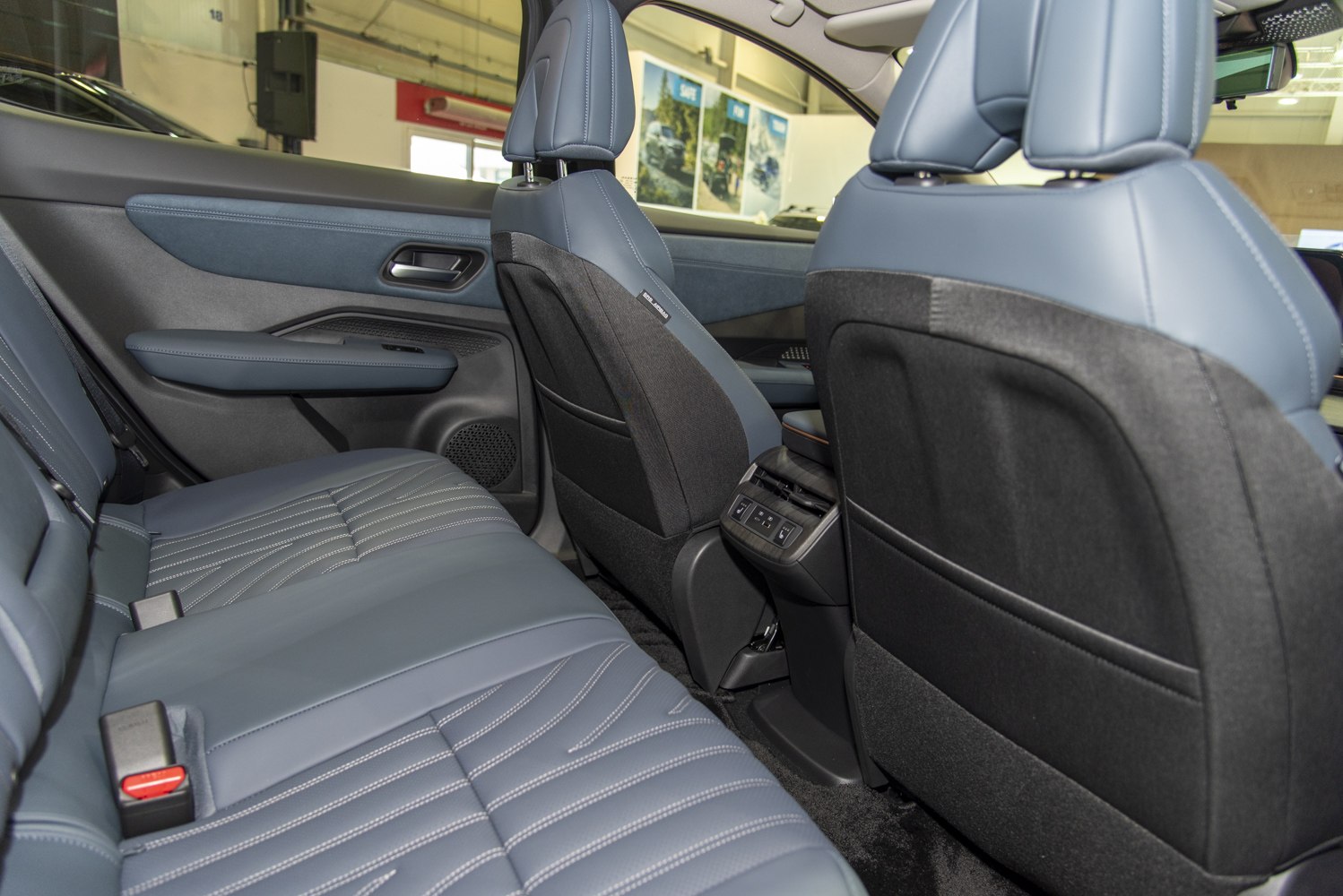 Rear seat interior with blue leather upholstery and rear climate control vents