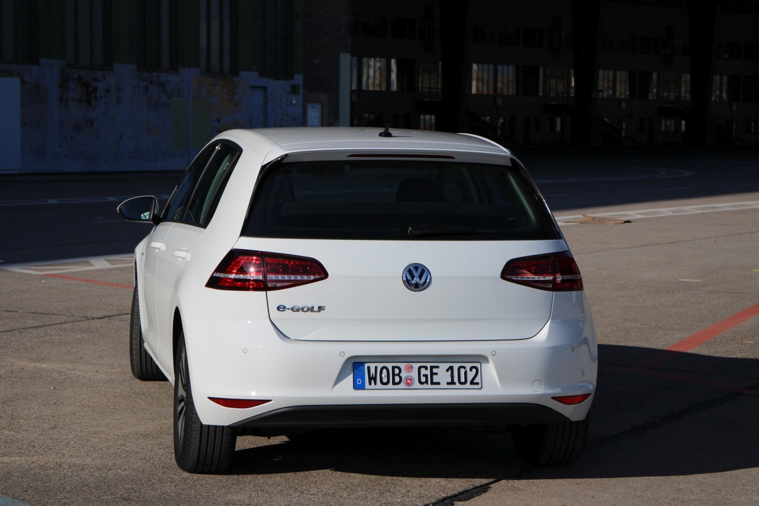 Rear view of white electric hatchback with LED taillights and license plate