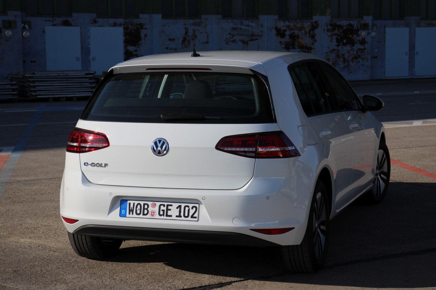 Rear view of white 5-door electric hatchback with distinctive taillights