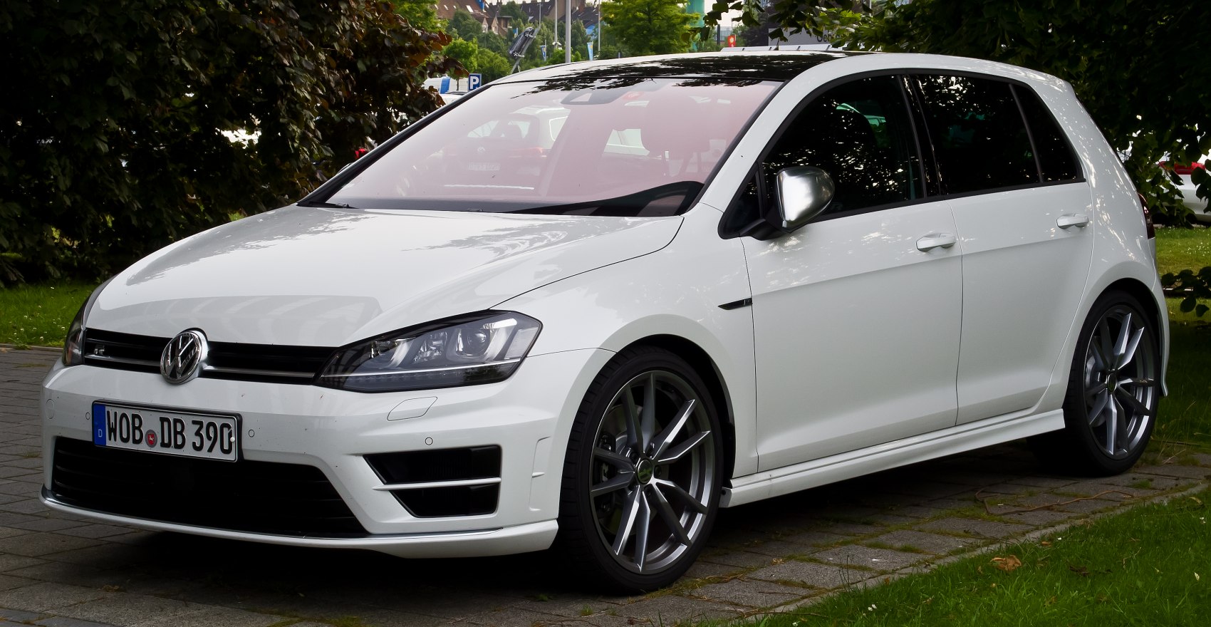 Front-side view of a white compact 5-door hatchback with sleek headlights and sporty alloy wheels
