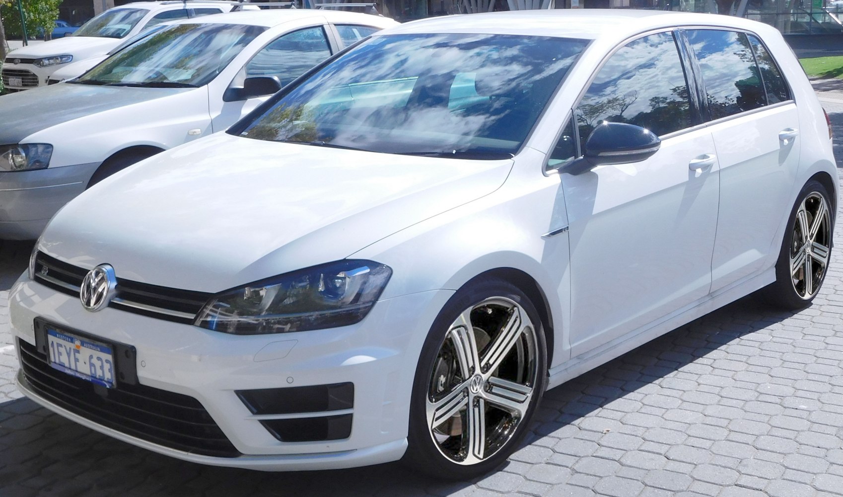 White 5-door hatchback with alloy wheels and sleek headlights